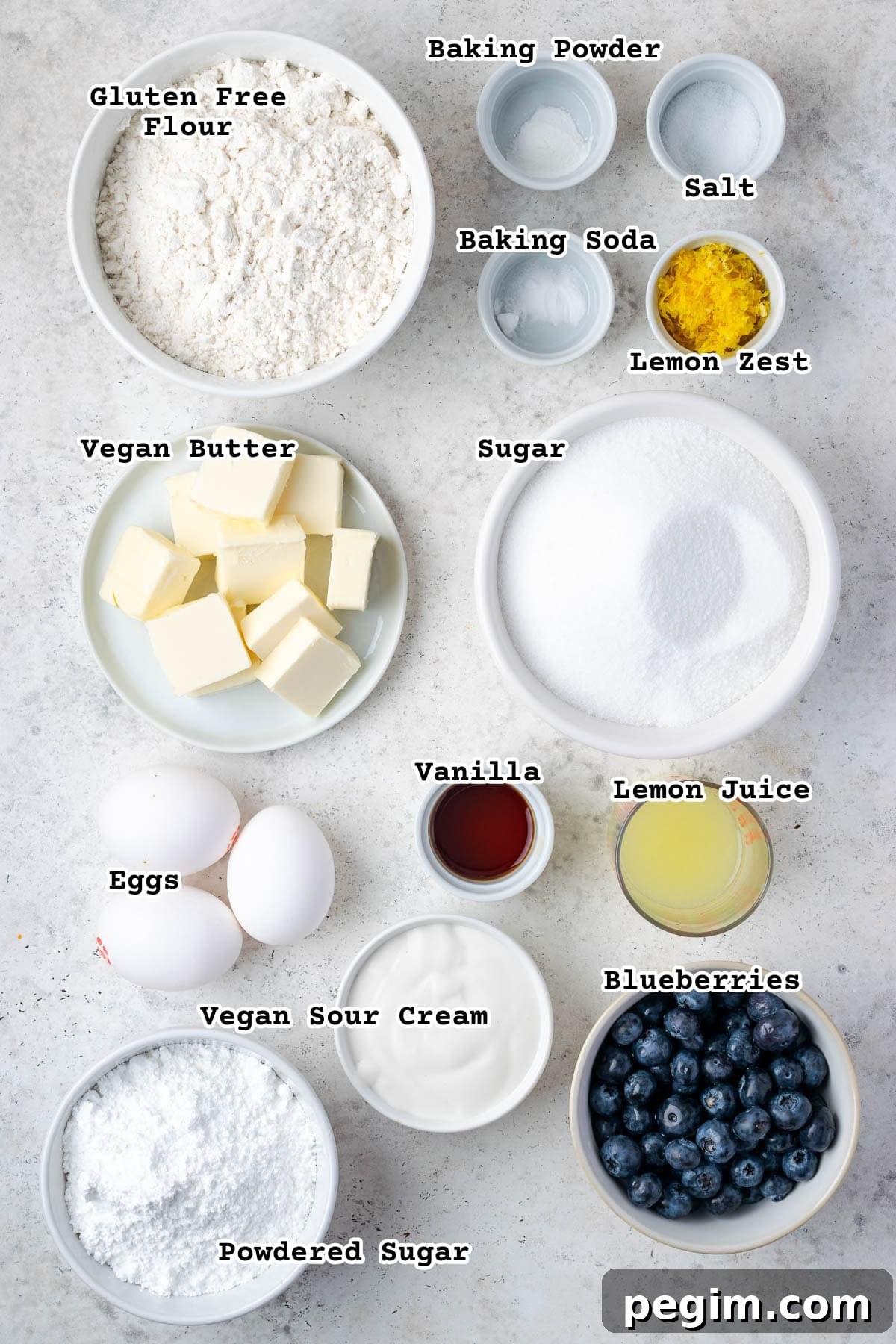 Ingredients for a gluten free lemon blueberry pound cake on a white counter.