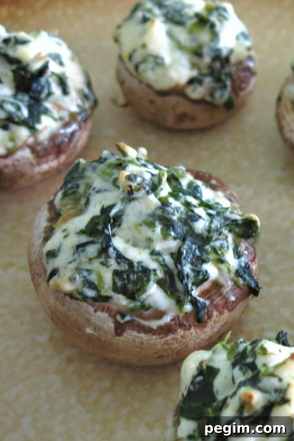 Platter of stuffed mushrooms with cream cheese and spinach.