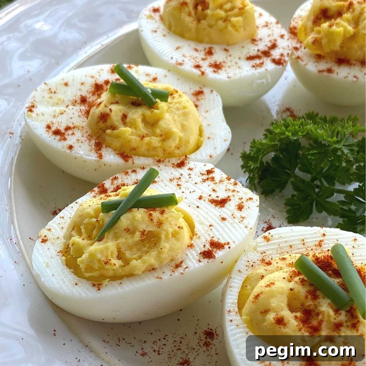 Keto deviled eggs in a semi-circle on a plate.
