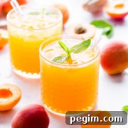 side angle super close up at a short glass filled with apricot nectar