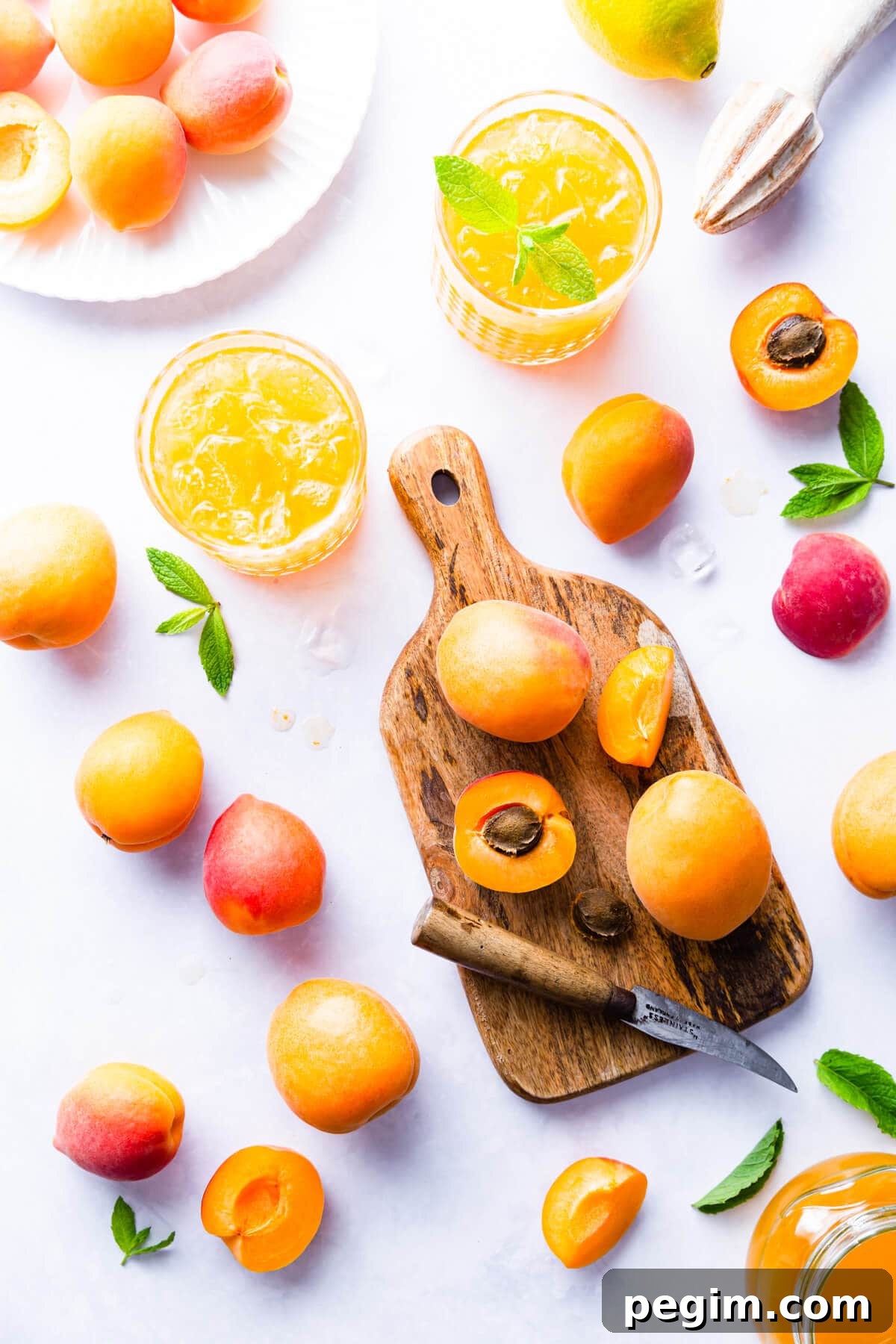 top view of fresh apricots and two glasses filled with apricot nectar