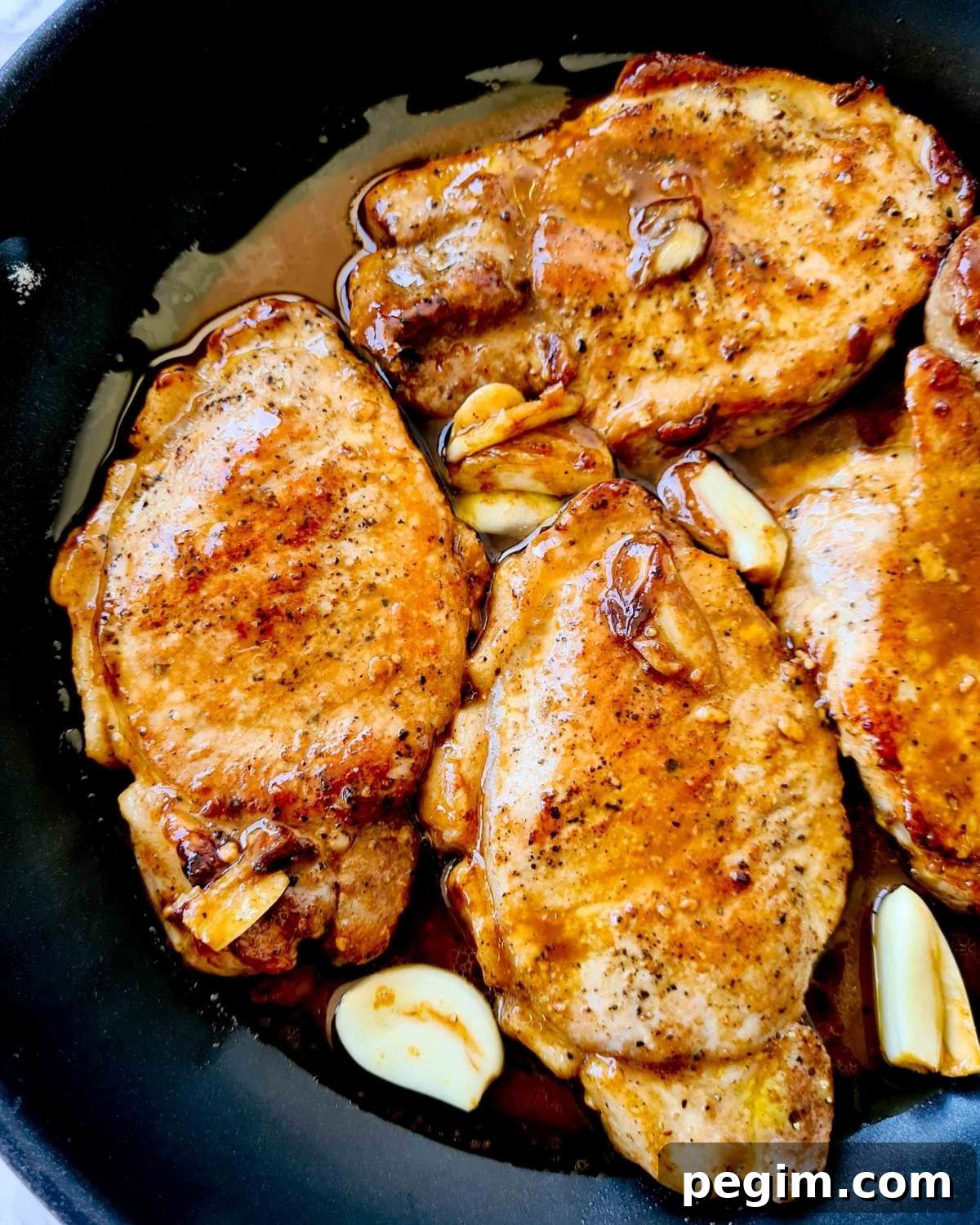 Close up of cooked pork chops in sauce