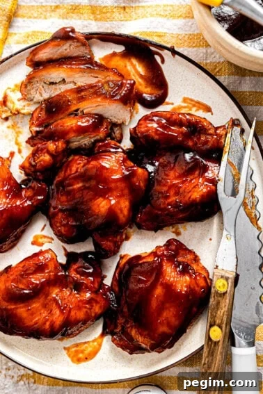 Plate of BBQ chicken being sliced.