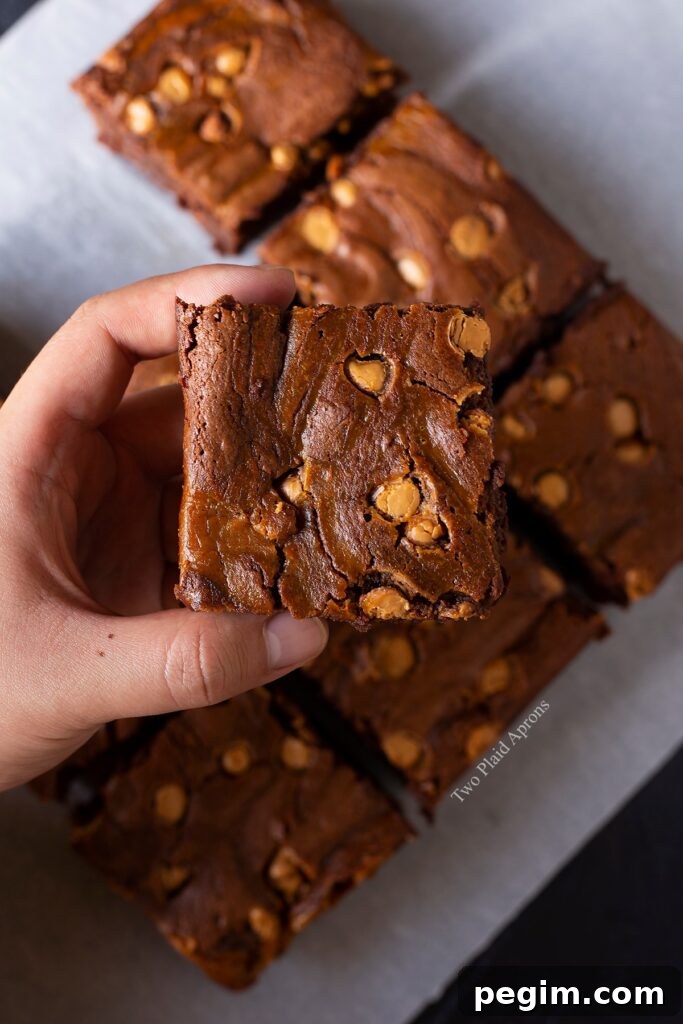 Holding a slice of the pumpkin butterscotch brownies.