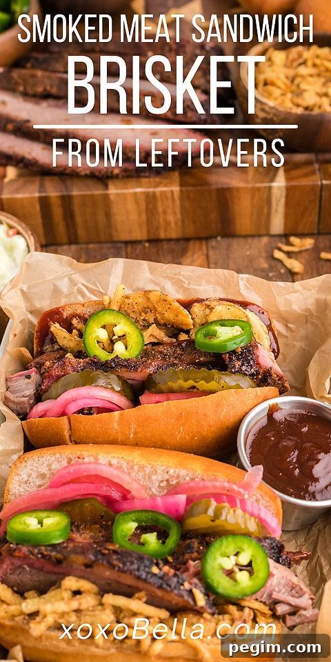 Best BBQ brisket sandwich piled high with pickles and pickled red onions served with barbecue sauce.