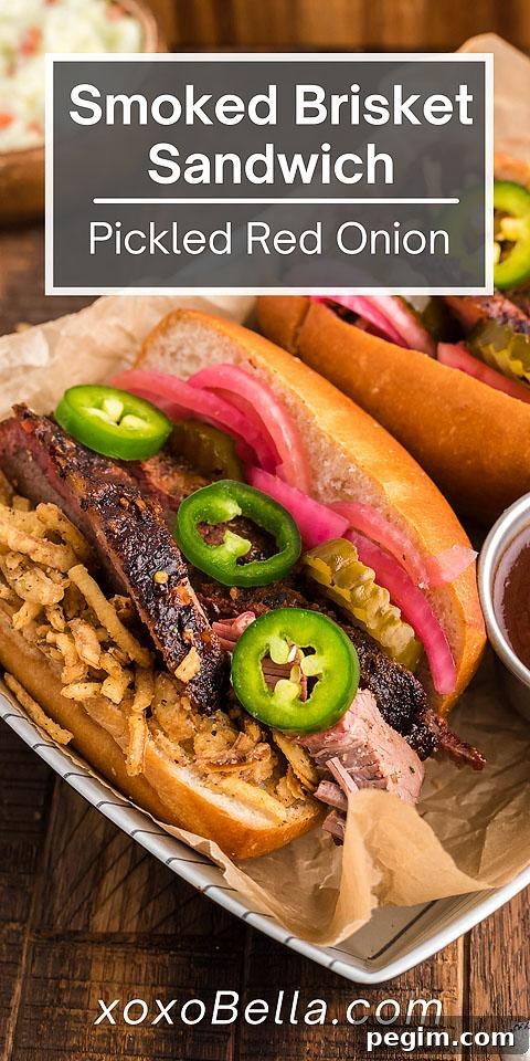 Smoked brisket sandwich with pickled red onions, jalapeño and crispy fried onions on a hoagie roll.