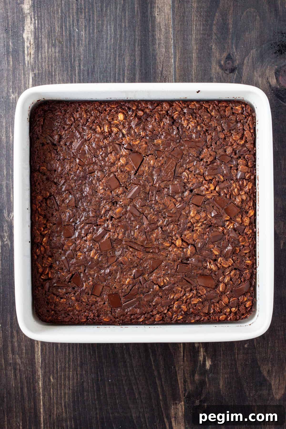 Chocolate baked oatmeal cooked and set in a square baking dish.
