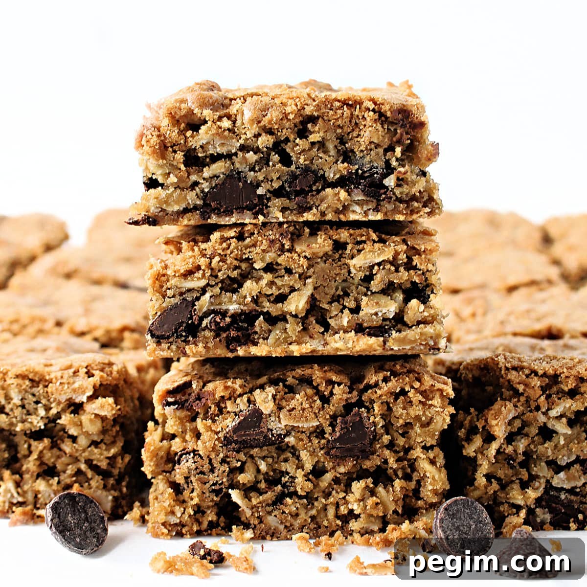 Stack of oatmeal bars showing interior with oats and chocolate chips.