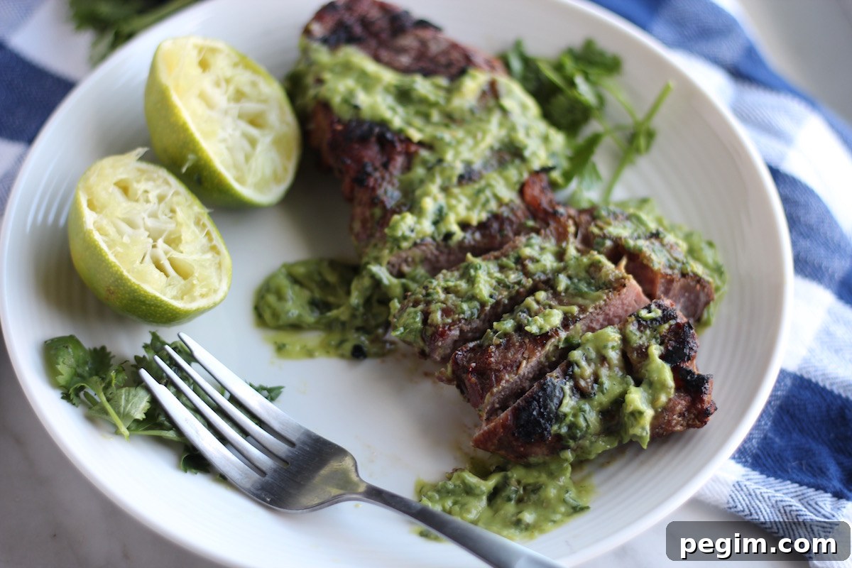 Grilled Steak with Creamy Chimichurri Sauce (AIP, Paleo) - juicy grilled steak is slathered with a tangy avocado herb sauce for an amazing meal! | fedandfulfilled.com