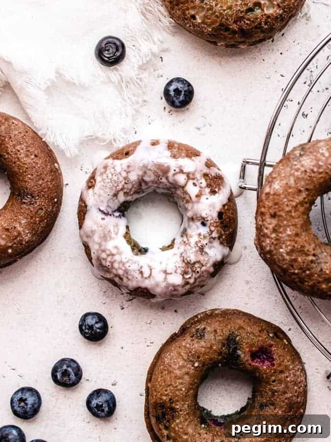 Overhead of blueberry cake donuts with center one doused in glaze