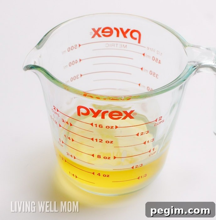 Melted beeswax and coconut oil in a large measuring cup