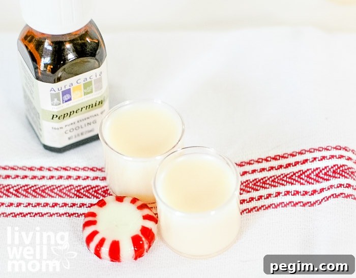 Peppermint lip balm with bottle of essential oil next to it
