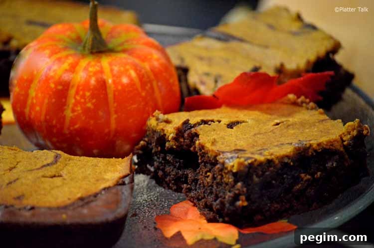 Pumpkin Cheesecake Brownies Recipe — Gooey Fall Dessert 5 A close-up of a brownie.