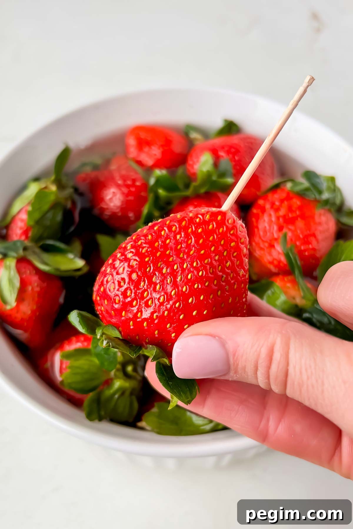 skewer stuck into fresh strawberry.