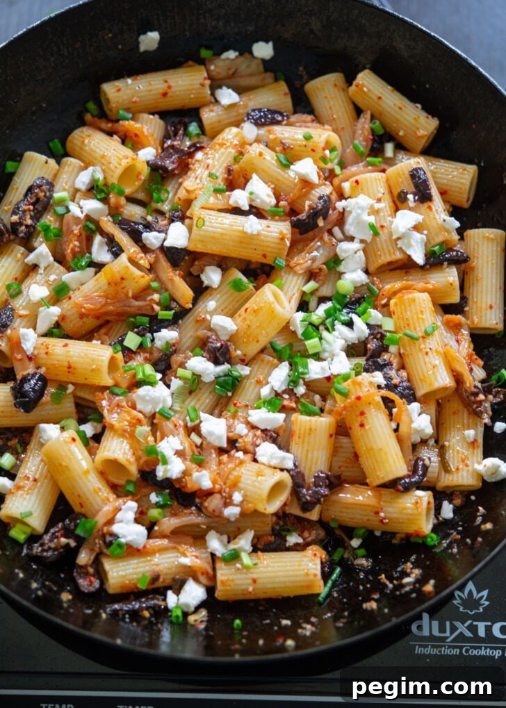 Feta cheese and green onion are added to kimchi olive pasta