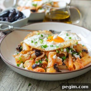 Kimchi olive pasta featuring feta cheese and fried egg as a Greek-Korean fusion dish.