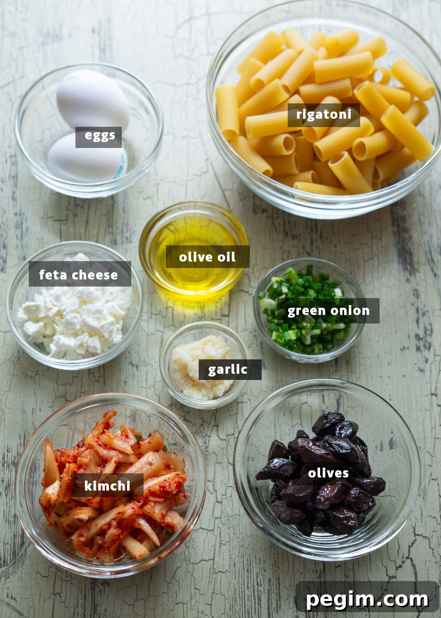 Ingredients for making kimchi olive pasta, Mediterranean-Korean fusion style.