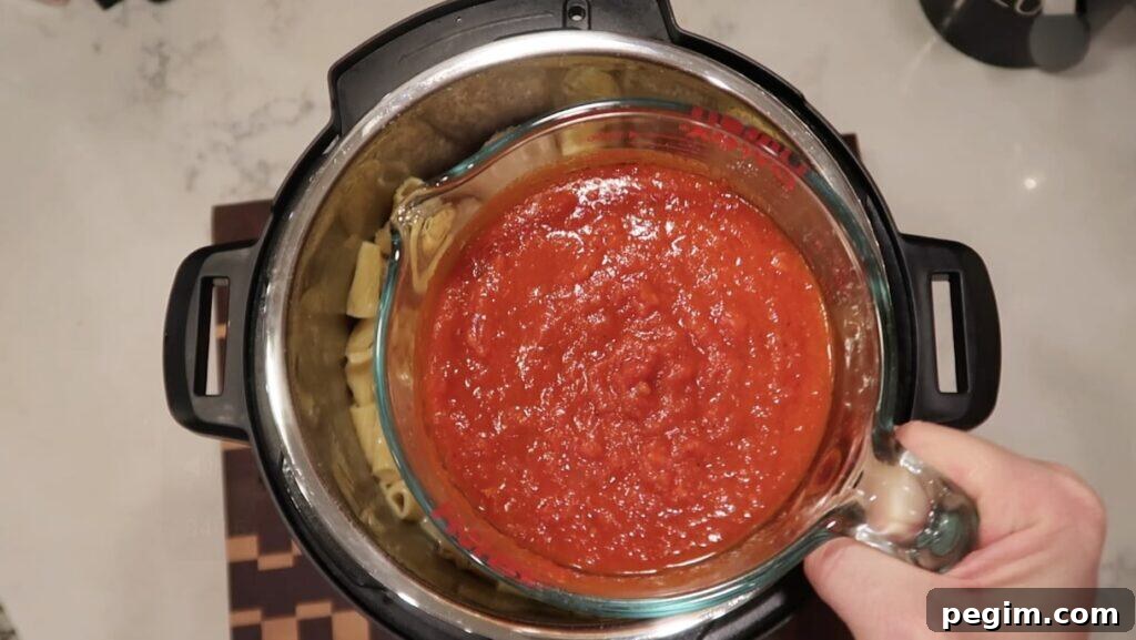 Adding marinara sauce to pot