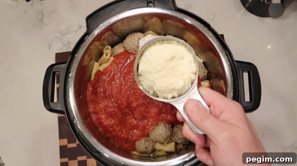 Adding grated Parmesan cheese to pot