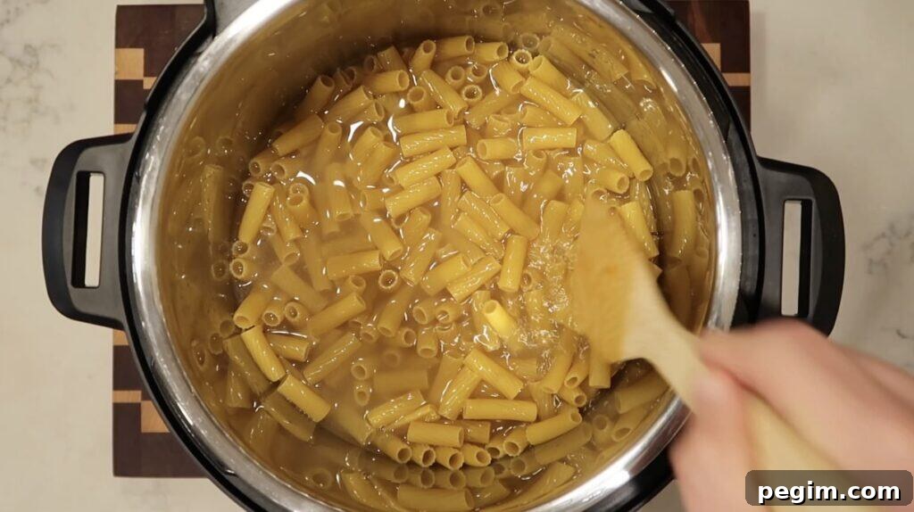 Submerging pasta in broth