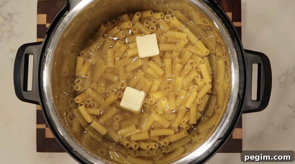 Topping pasta with two pats of butter