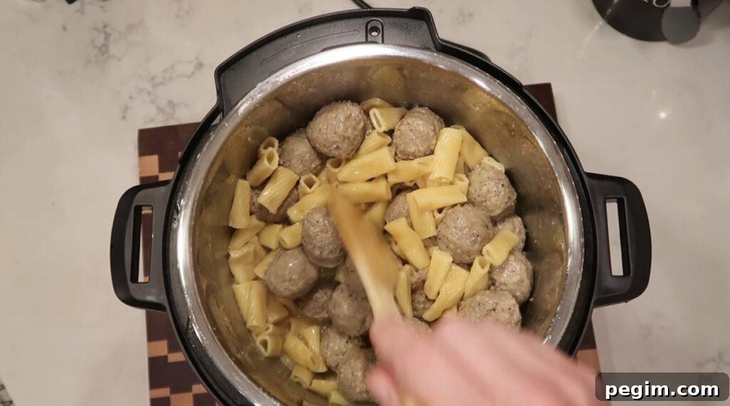 Stirring pasta and meatballs