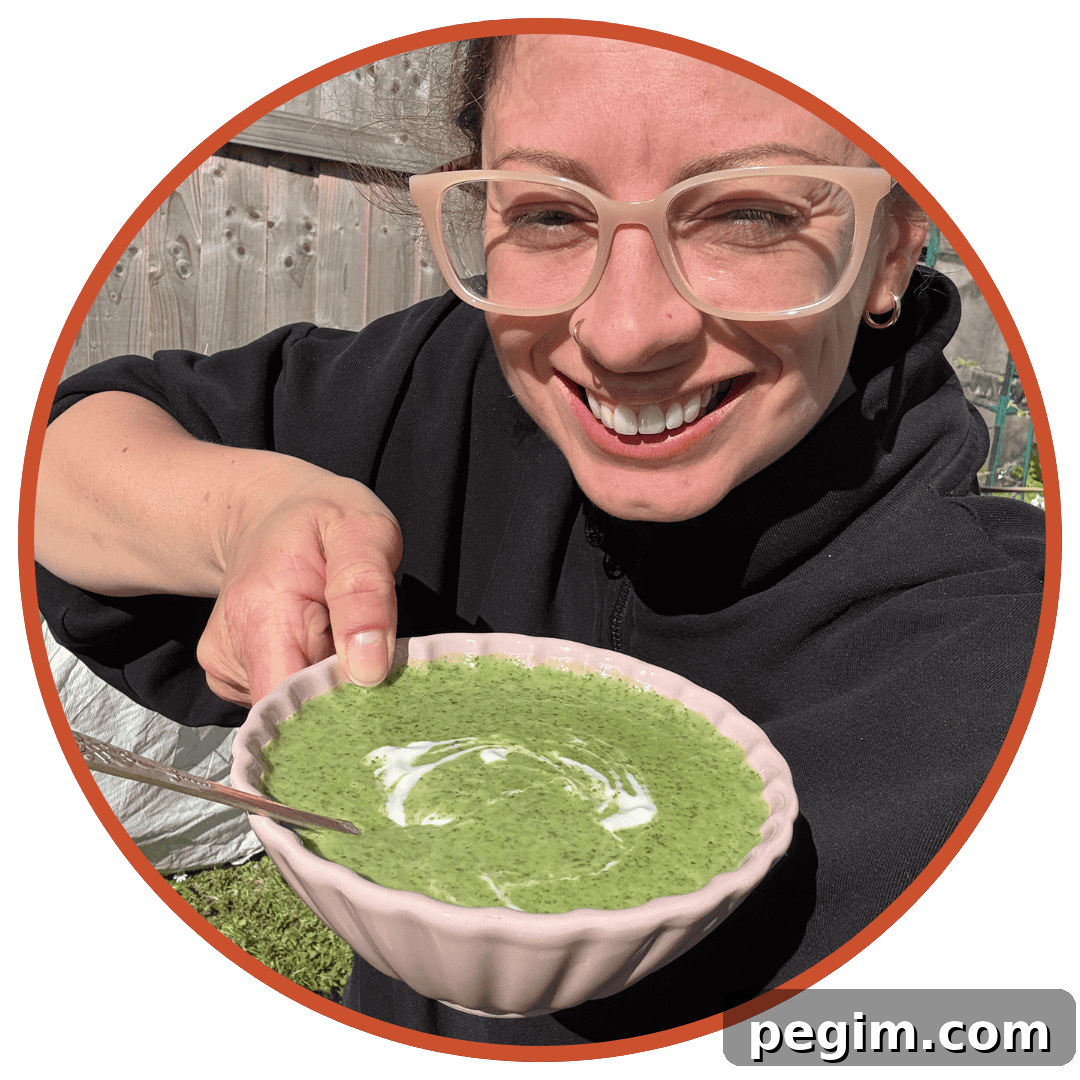 Author Sarah Howells looking very happy in the garden holding up a bowl of watercress soup.