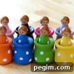 wooden peg dolls painted in rainbow colors