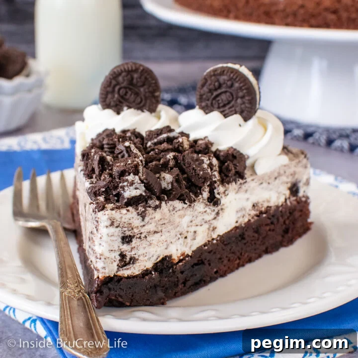 A white plate with a slice of Oreo mousse cake on it.