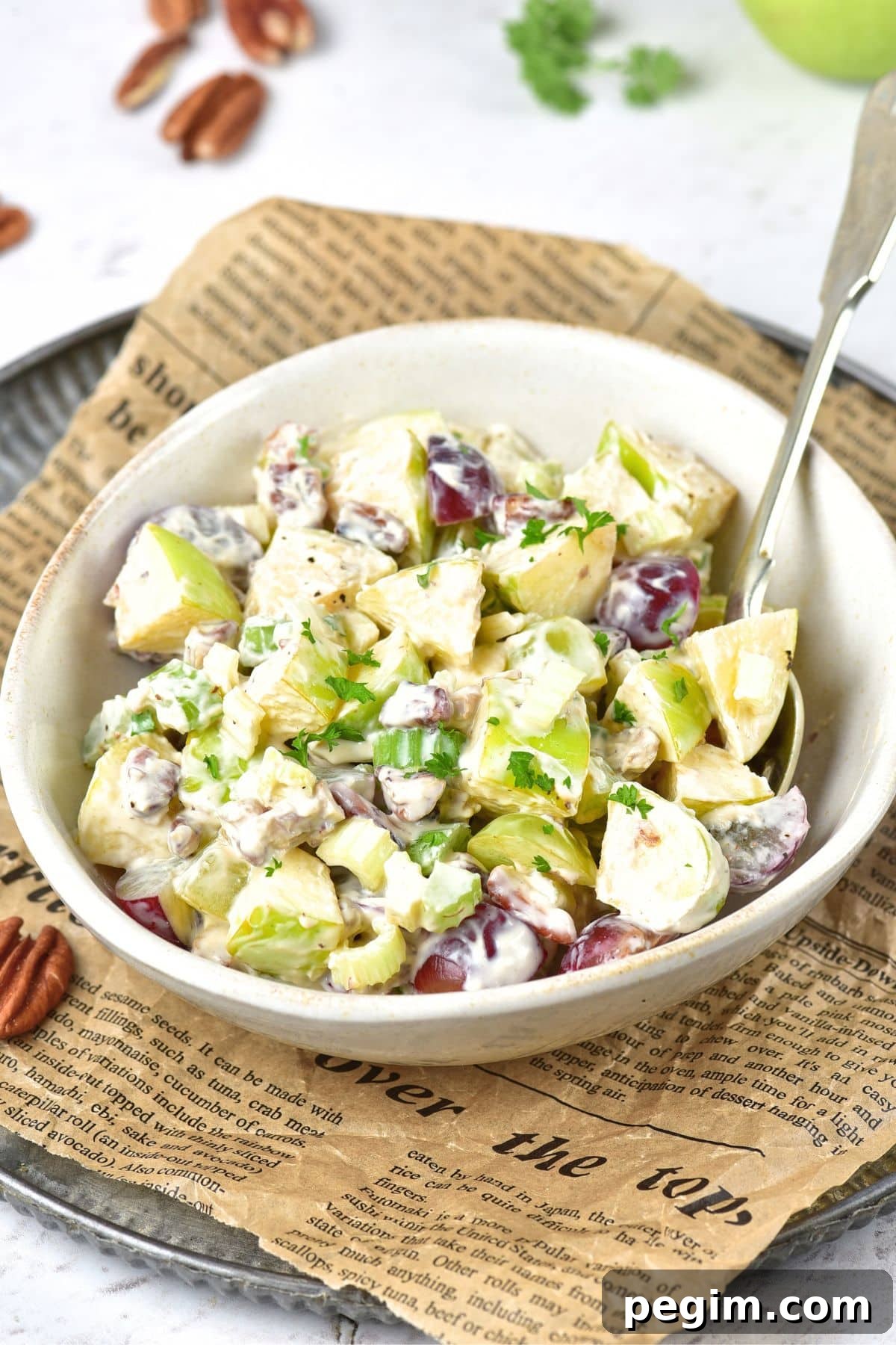 A bowl of vegan waldorf salad with grapes, chicken and celery