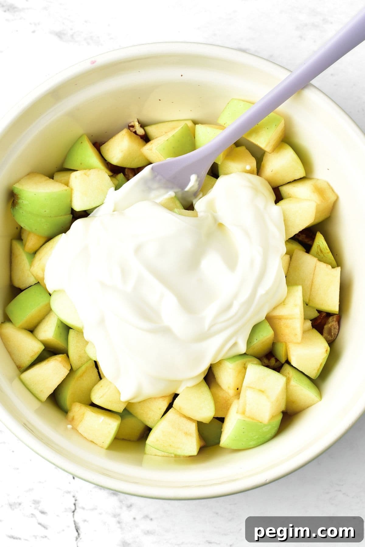 Creamy dressing on top of chopped apples