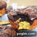 Deep Dish Brookies with a bite out of one on top of a muffin pan.