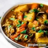 A bowl of vegetable stew sprinkled with parsley