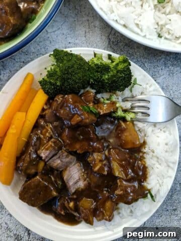 Caramelised pork and pineapple on a bed of white rice.