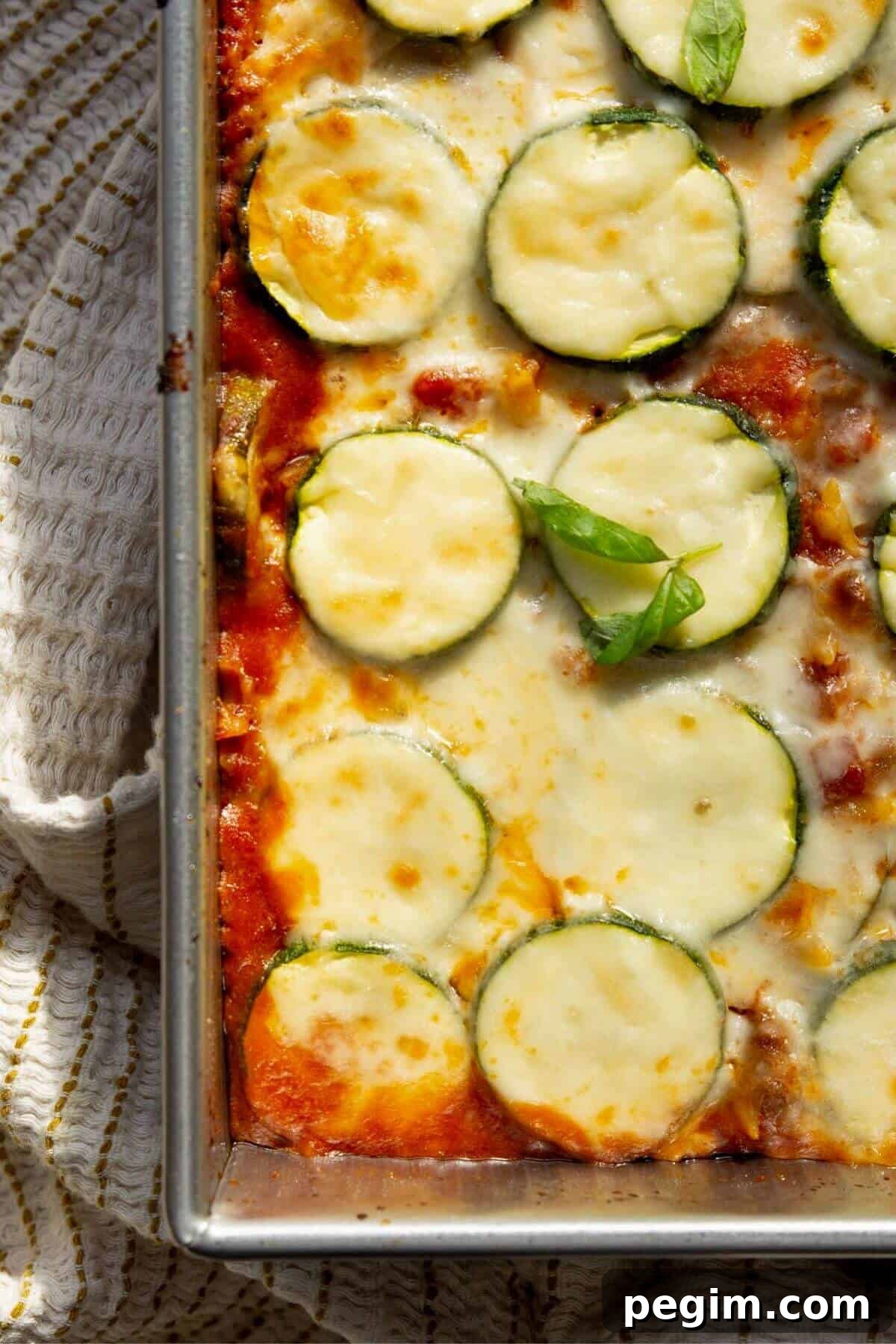 Easy cottage cheese ground beef and zucchini casserole with melted cheese.