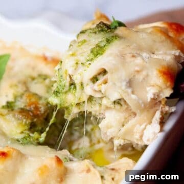 Easy and creamy lightened-up chicken and broccoli pesto lasagna with healthy white Alfredo sauce.