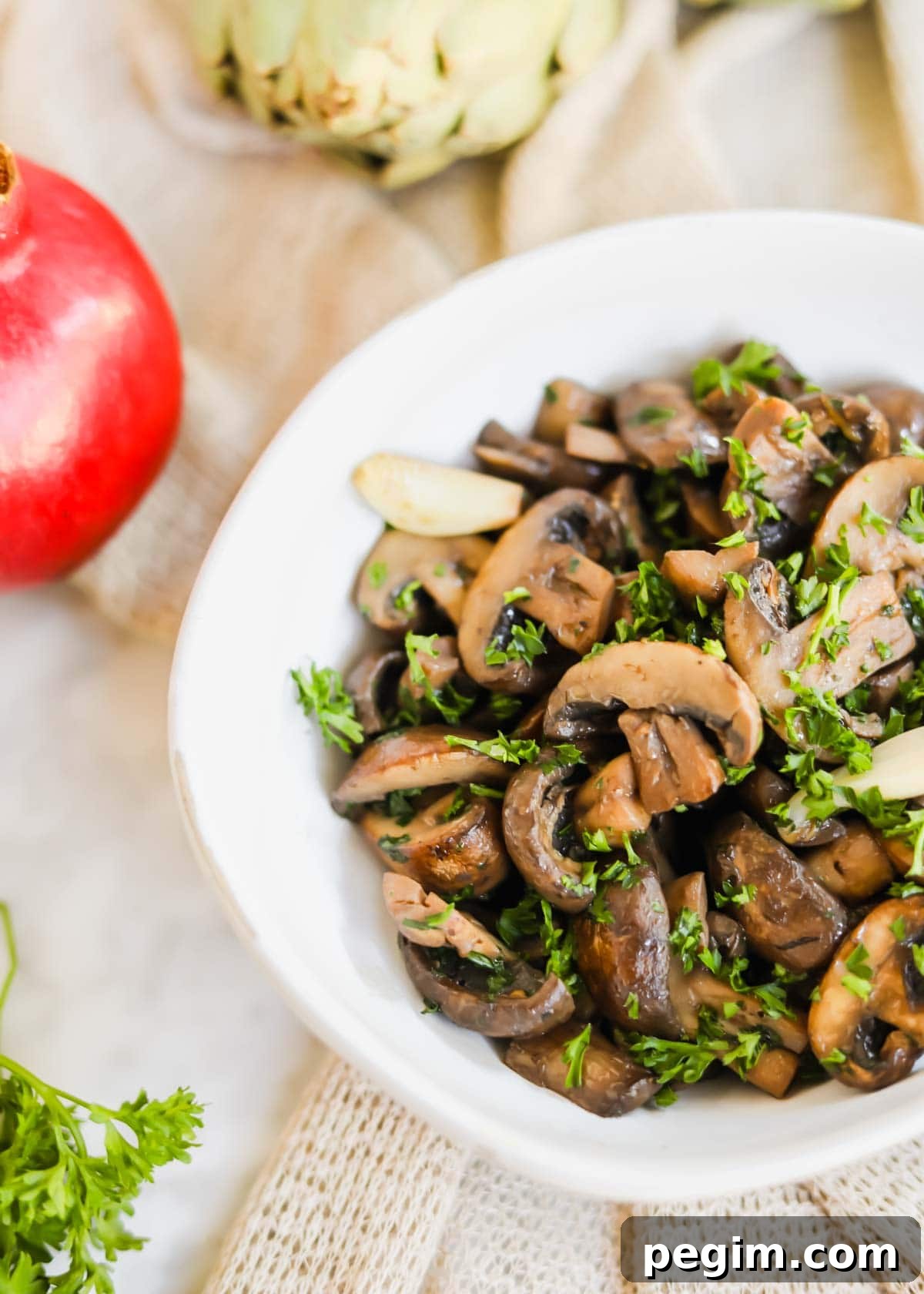 20 Delicious Side Dishes to Serve with Roasted Chicken 11 Sautéed mushrooms with White Wine in white bowl with parsley, garlic, and seasoning.