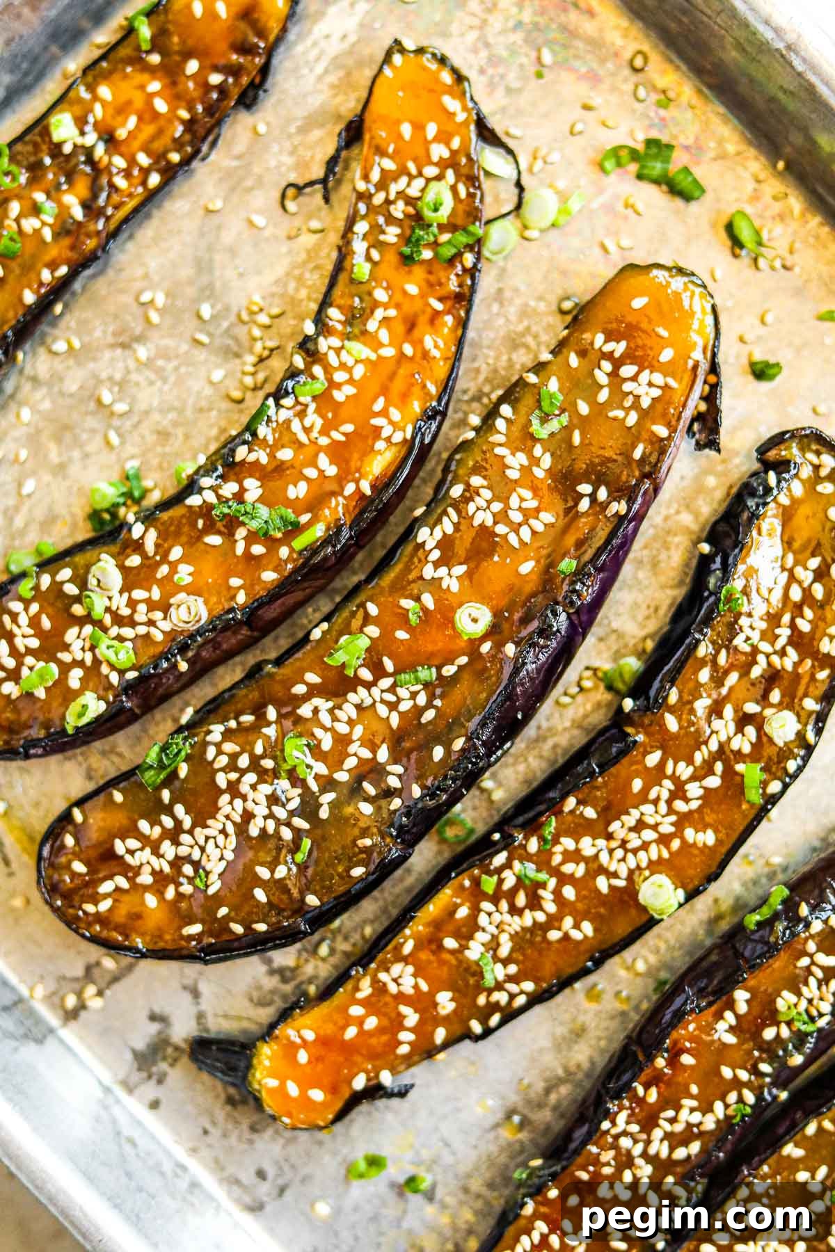 20 Delicious Side Dishes to Serve with Roasted Chicken 14 Miso-glazed Japanese eggplant with sesame seeds and sliced green onions on a baking sheet.