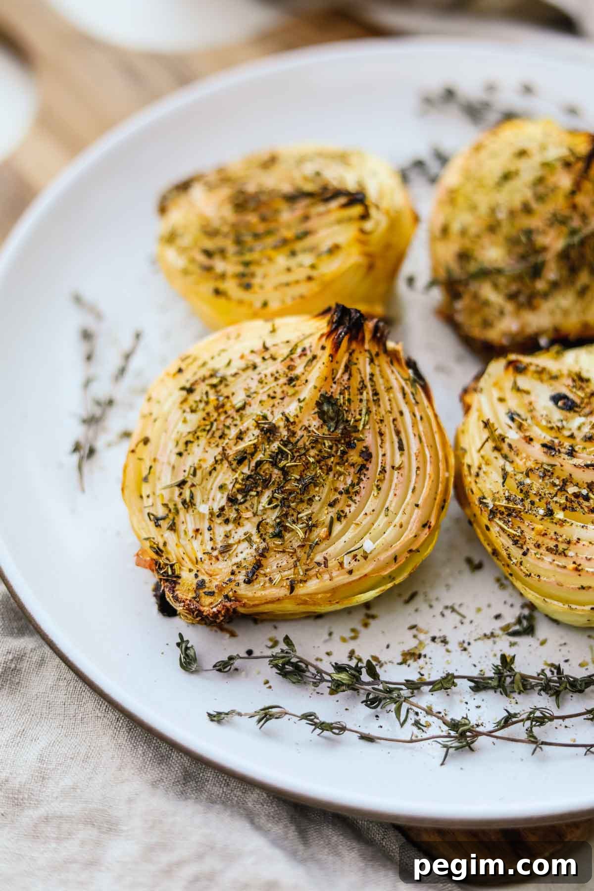 20 Delicious Side Dishes to Serve with Roasted Chicken 15 Oven roasted onions with herbs baked and served on a Heath Ceramics platter.