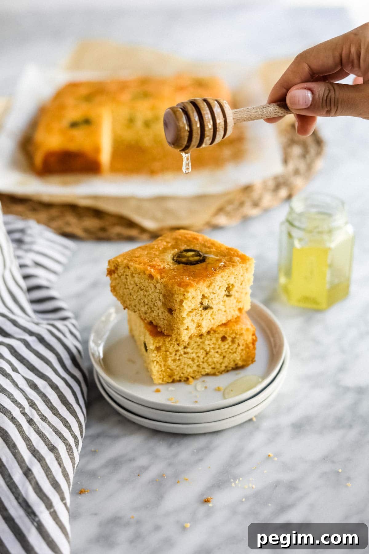 20 Delicious Side Dishes to Serve with Roasted Chicken 16 Jalapeño Cheddar Cornbread with Miso sliced on plate with butter and honey.