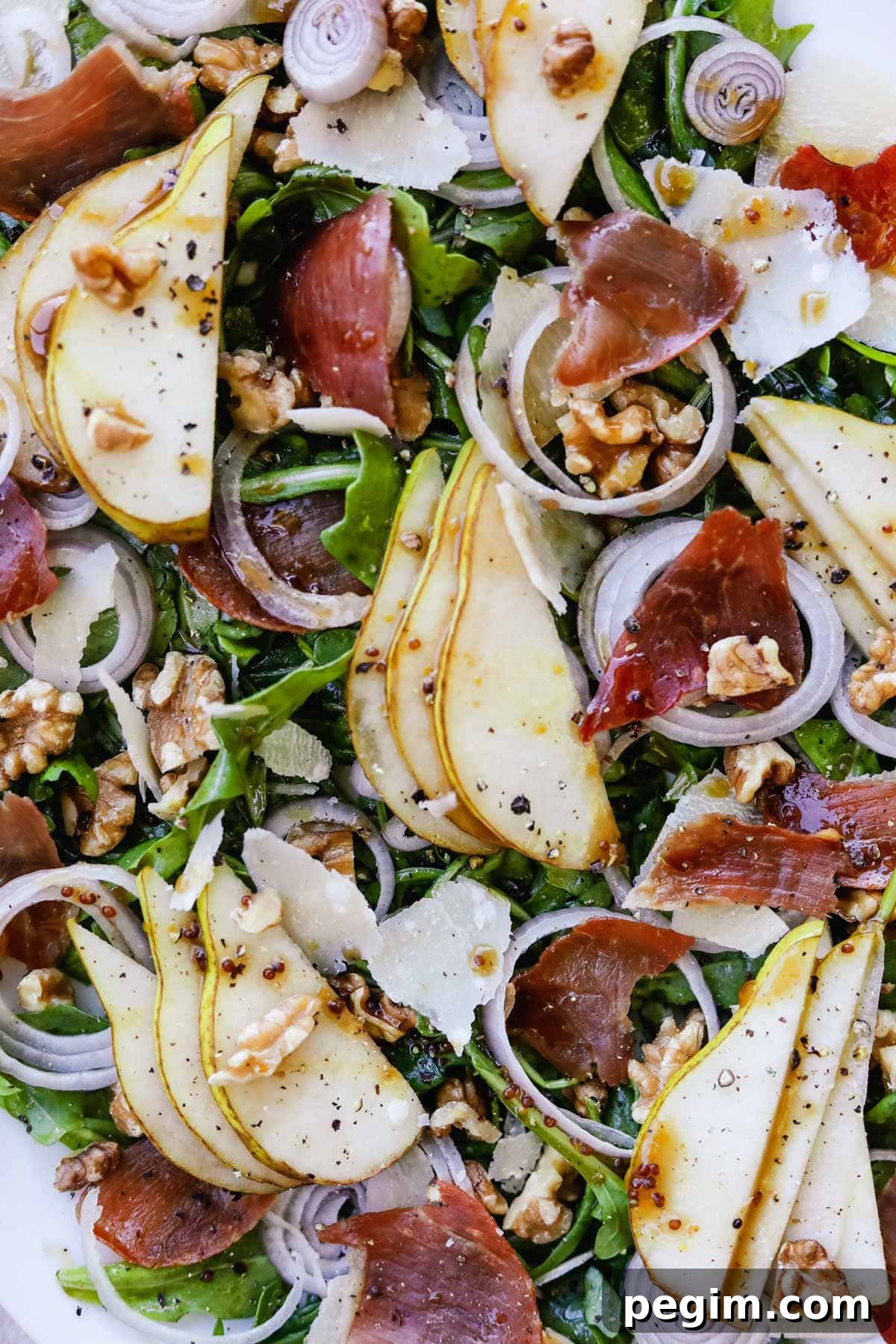 20 Delicious Side Dishes to Serve with Roasted Chicken 18 Closeup shot of arugula salad with pear, crispy prosciutto, shallots, parmigiano-reggiano, and walnuts.