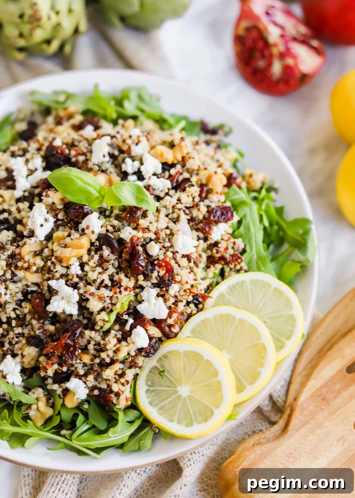 20 Delicious Side Dishes to Serve with Roasted Chicken 22 Harvest Salad with Quinoa and Arugula and lemon slices on plate.