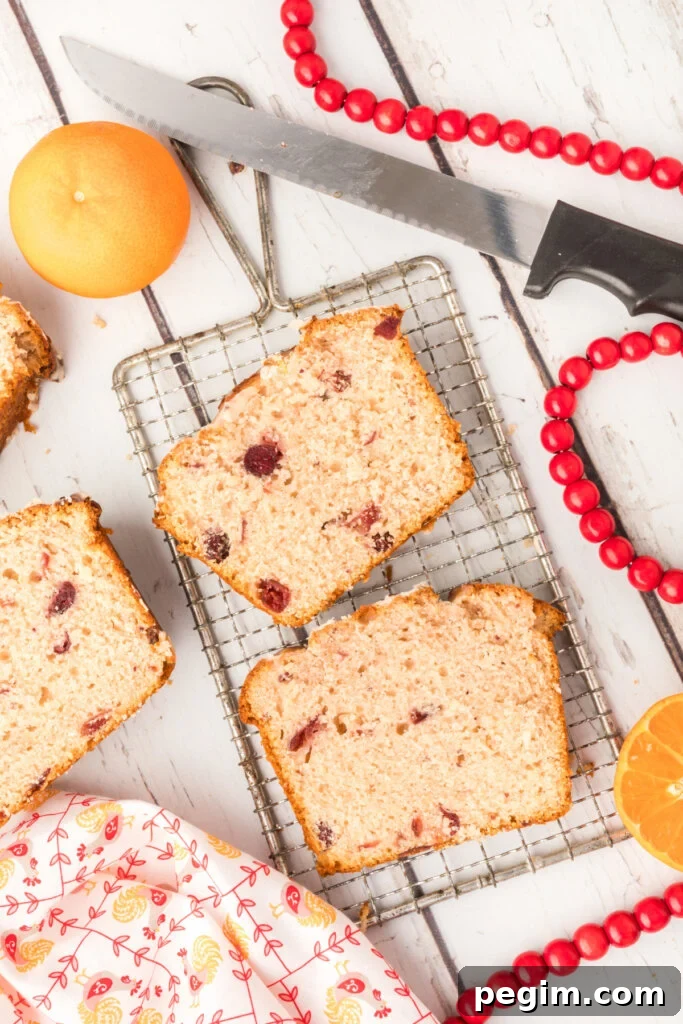 slices of orange cranberry bread on small cooling rack
