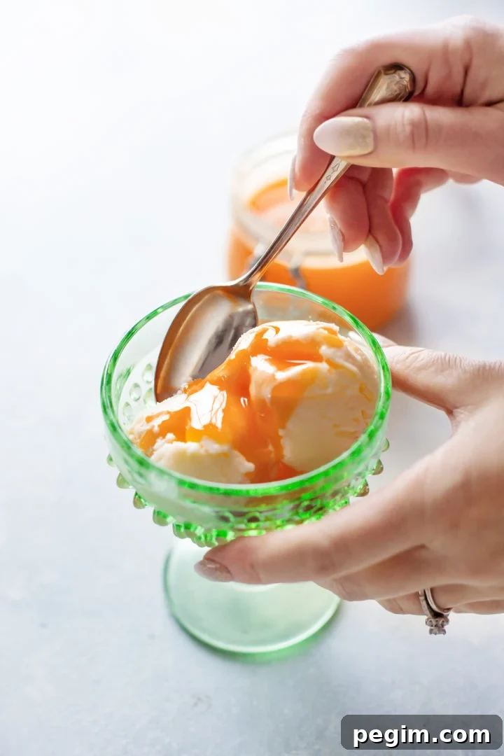 photo of a woman eating this grapefruit curd recipe on a bowl of ice cream