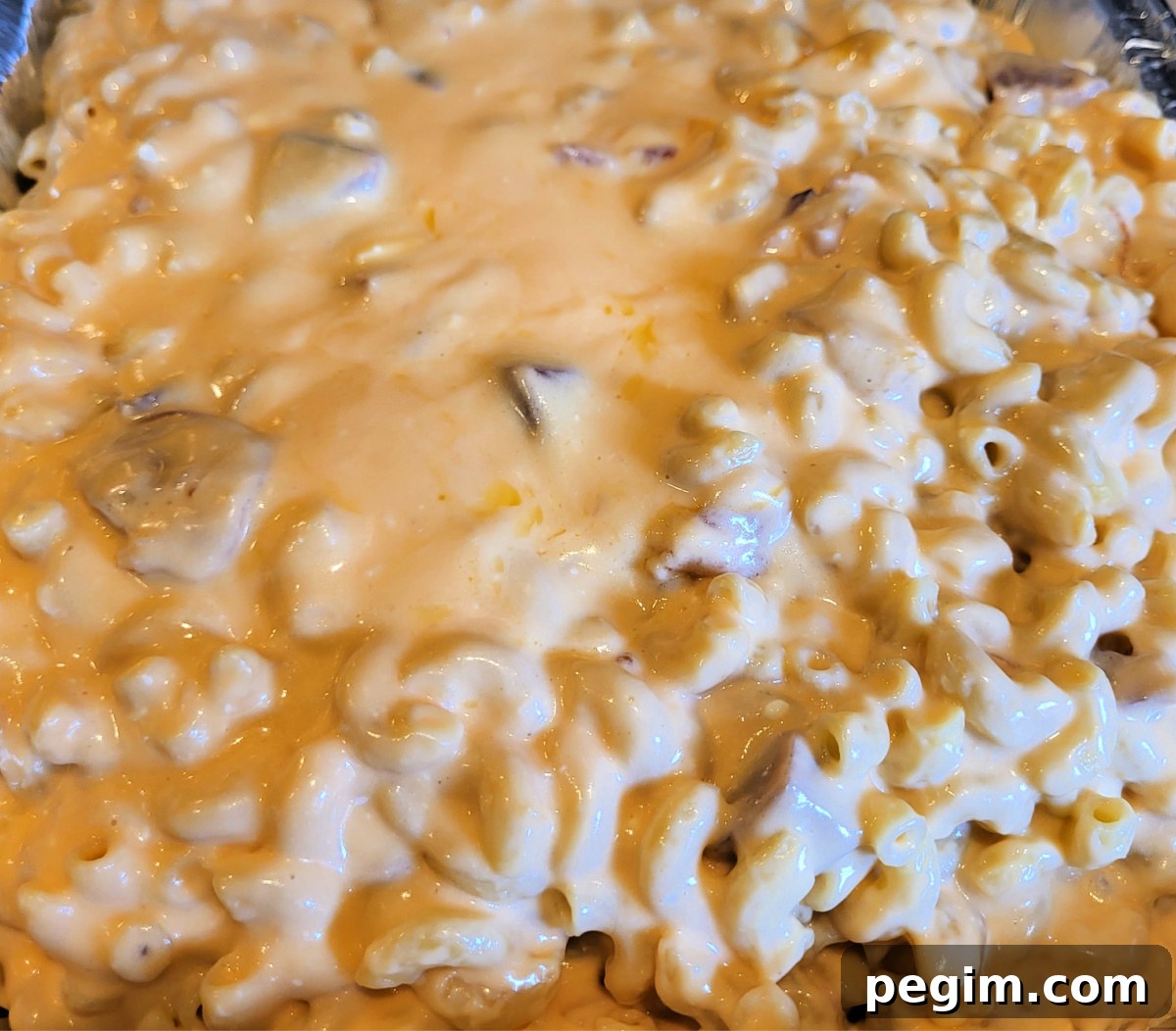 Smoked Ham Mac And Cheese in tin foil pan ready to smoke.