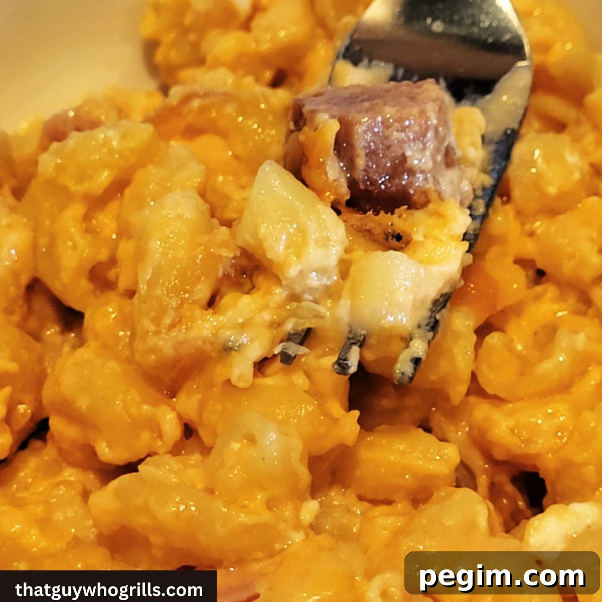 Smoked Ham Mac and cheese on a fork in a bowl
