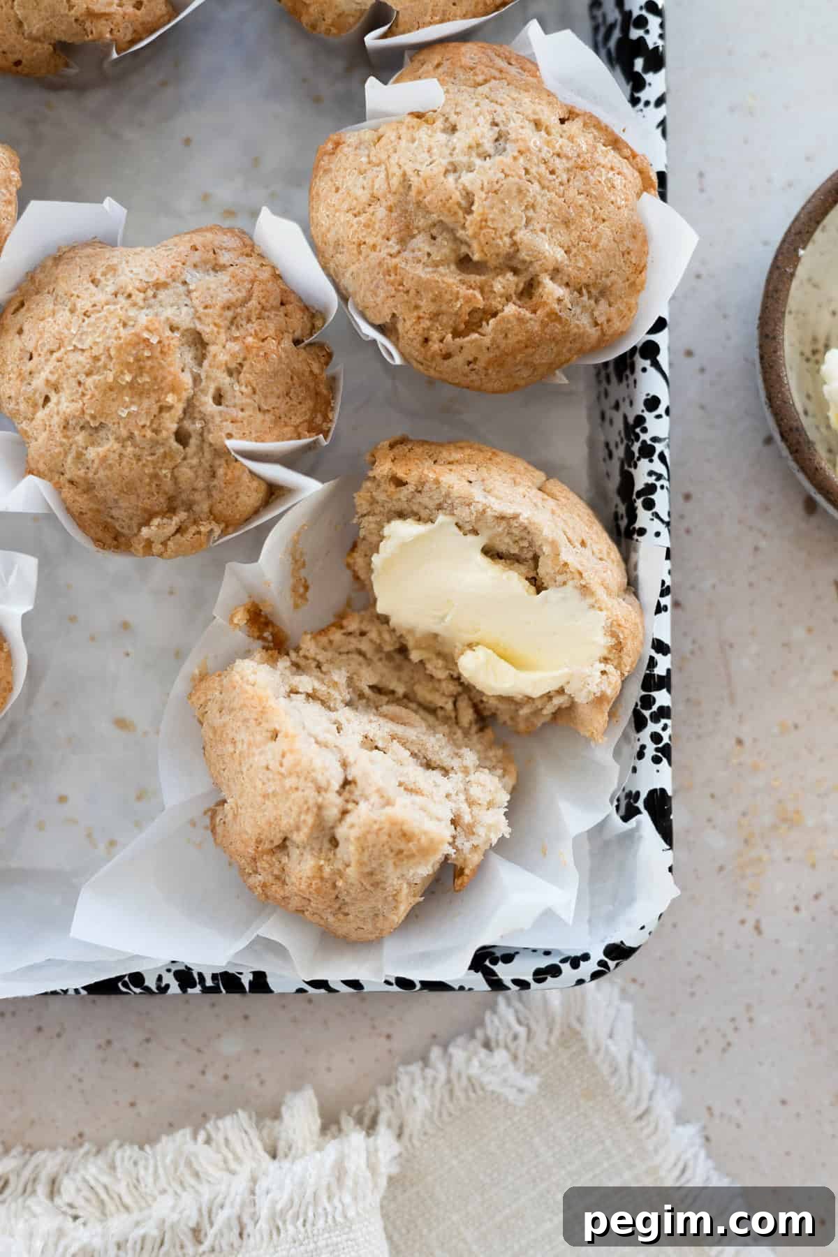 Sourdough Discard Banana Muffins on white parchment paper.