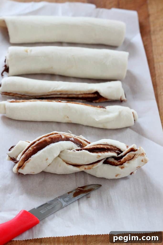 Cutting the puff pastry in half and twisting it.