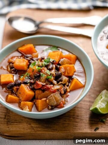 sweet potato black bean soup in bowl on wooden board