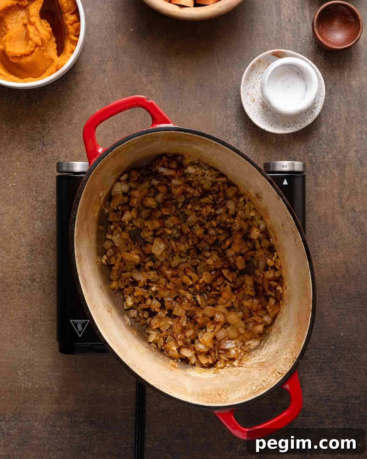 onions and spices cooked in soup pot.